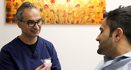 Dr. Kar talking to male patient