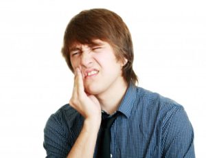 A man holding his jaw in pain.